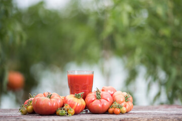 Fresh tomato juice, on a wooden background