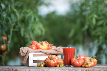 Fresh tomato juice, on a wooden background