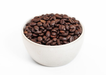 Bowl plate with fresh raw aroma coffee beans on white background.
