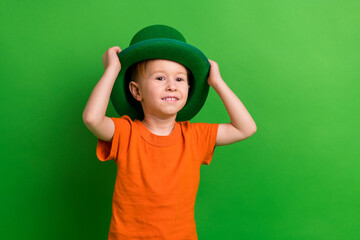 Photo of adorable schoolboy wear leprechaun costume enjoy family saint patrick event isolated on...