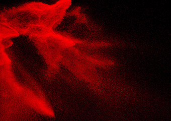 Red dust particles explosioon on black background.Red powder splash.