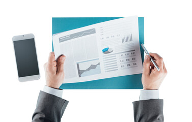 Business man checking a financial report