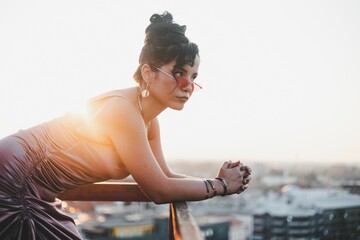 Sexy Caucasian white woman in sunglasses on the balcony at dreamy sunshine