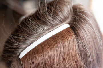 Hair ribbons for extensions on a woman's head at home. Hair extensions to thicken your own....