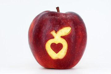 Fototapeta na wymiar Fresh juicy apple with cutout - apple and heart. White background