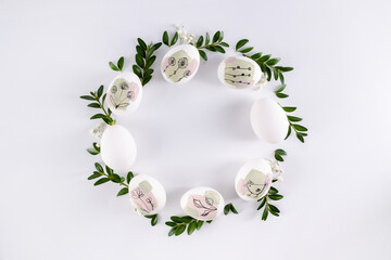 Modern hand painted easter egg on white background in the shape of a wreath. Happy easter poster and banner for greeting text. Top view