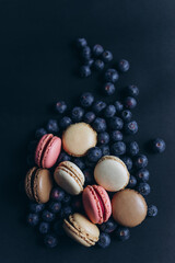 Food photography, macarons and blueberries on a black background 