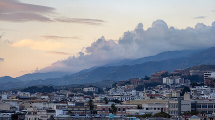 Homes and Apartment Buildings in a touristic city Messina, Sicilia, Italy. Cloudy Sunrise Sky. Aerial