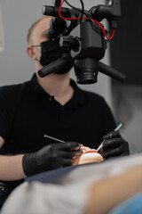 Dentistry a dentist examines a patient through a microscope