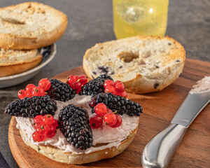 bagel with berries and cream cheese spread