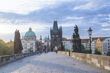 Beautiful view of Old Town Tower of Charles Bridge at dawn in Prague, Czech Republic