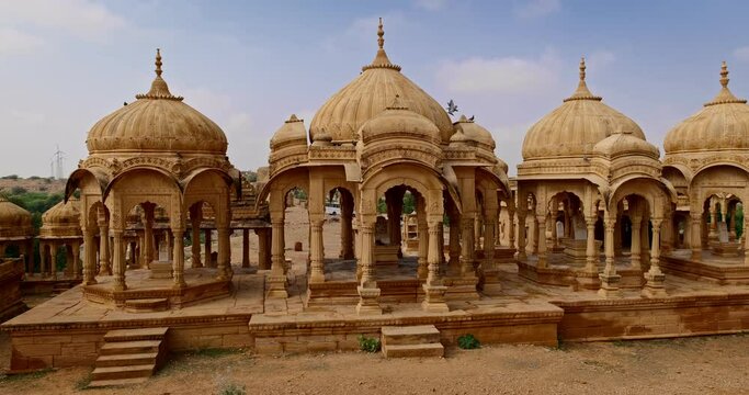 Bada bagh cenotaphs (Hindu tomb mausoleum) made of sandstone in Indian Thar desert. Jaisalmer, Rajasthan, India. Horizontal panning