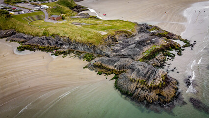 Cape of the Virgin Mary on Inchydoney beach, southern coast of Ireland, top view. A popular Irish beach, a picturesque coastal cliff. Irish nature.