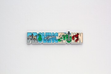 Colourful PVC souvenir fridge magnet of Provincetown, USA on white background. Travel memory concept. Gift typical product for tourists from foreign trip. Home decoration. Top view, flat lay, close up