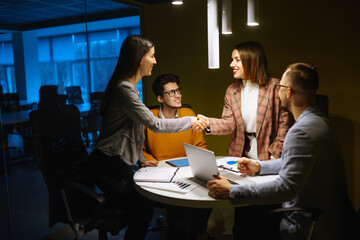 Workaholics businesspeople brainstorming financial company ideas analyzing strategy paperwork late at night in business office.Business Partners Discuss Financial Reports, Plan Investment Strategy.