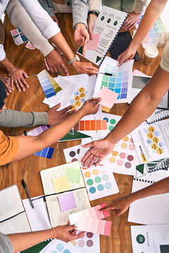 Color, design palette and hands of business people on desk for branding meeting, strategy and marketing. Teamwork, paper and top view of designers brainstorming ideas, thinking and creative project
