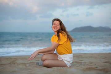 Fototapeta na wymiar Portrait of happy girl, young carefree woman enjoying summer vacation on sea, walking on beach sand, smiling and having fun in tropical country, relaxing on nature. Summertime, happiness concept.