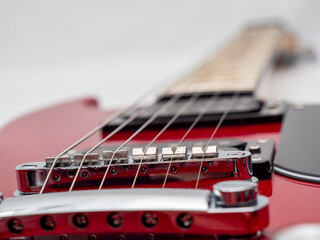 Fototapeta na wymiar Red electric guitar isolated on white background. Musical instrument guitar. Close-up.