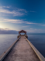wooden pier on the sea at sunrise 
