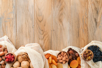 Tu Bishvat celebration concept. Mix of dry fruits and nuts almonds, hazelnuts, walnuts, apricots, prunes, cherries, raisins, dates, apples, figs over wooden table. Jewish holiday, new year of trees.