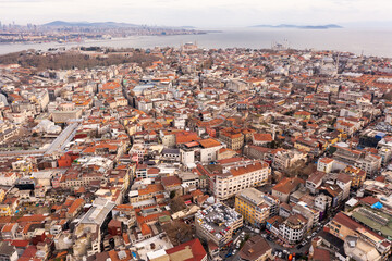 Fototapeta premium The New Mosque and Galata Bridge near Golden Horn in Istanbul, Turkey. Panoramic view from roofs of Buyuk Valide Han. Grand Bazaar and Beyazit Tower