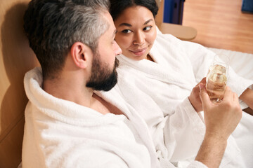 Fototapeta premium Woman and her companion celebrating anniversary in hotel room