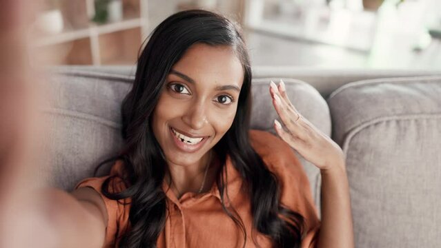 Woman, phone call and video selfie of influencer on living room sofa talking about life, vlog or social media at home. Portrait of happy female POV on smartphone conversation or networking on couch