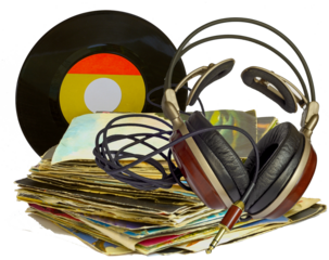 Stack of old 45 RPM vinyl records and headphones with wooden earphones