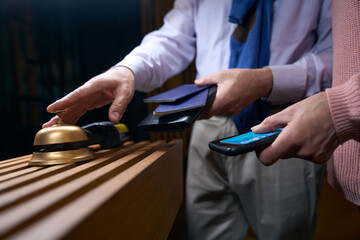 Man in travel clothes calls the hotel staff for registration
