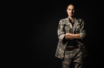 Serious Army Soldier on black background.