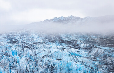 Glacier ice, Glacier Bay National Park and Preserve in the U.S. state of Alaska. Misty moody cloudy day.