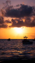 Fototapeta na wymiar Sunrise on the beach with boats