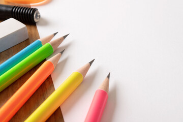 Bunch of sharp pencil and eraser on white paper still life image