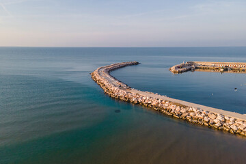 Aerial view of a breakwaters in Peschici harbour and port, Gargano Natural Park, Puglia, Italy.