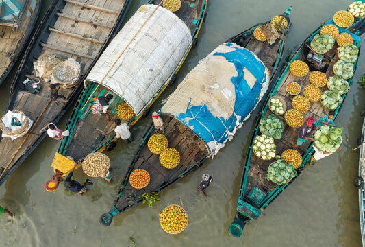 Aerial view of people working on traditional boats trading fruits along the river, Keraniganj, Dhaka, Bangladesh.