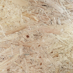 osb board closeup, texture of characteristic for an oriented strand board wood strands. Pressed wooden board panel background