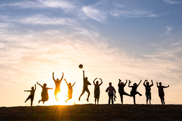 Silhouette of happy business group team over sunset sky. Success and teamwork concept in company with hands up over beautiful sunset sky for business success and teamwork concept in company
