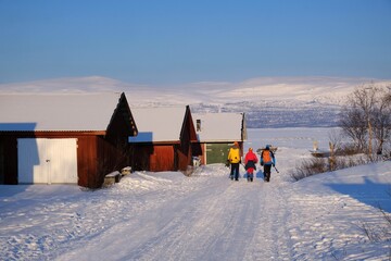 Group of tourists in Abisko is going to Lake Torneträsk (Tornestrask) in winter scenery. Abisko National Park (Abisko nationalpark),  Sweden, Arctic Circle, Swedish Lapland