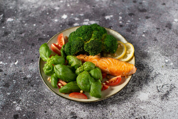 Baked fish salmon garnished with broccoli and tomato. Dietary menu. Fish menu.
