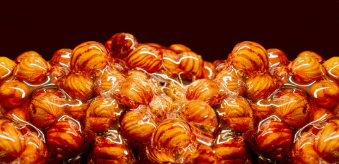 Delicious sweet hazelnut nuts in sugar caramel. Preparation of desserts in a pastry shop from natural ingredients. Vegan