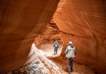 Hikers in Peek-a-boo slot canyon, Utah.