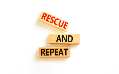 Rescue and repeat symbol. Concept words Rescue and repeat on wooden block on a beautiful white table white background. Business rescue and repeat concept. Copy space.