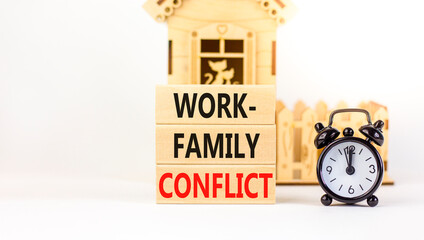 Work-family conflict symbol. Concept words Work-family conflict on wooden block on a beautiful...