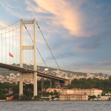 Bosphorus Bridge, or Bogazici Koprusu, and Building of the General Directorate of Coastal Safety, or Kiyi Emniyeti Genel Mudurlugu before sunset, Istanbul, Turkey