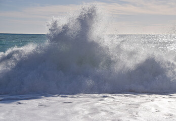 Waves splash against a beach.