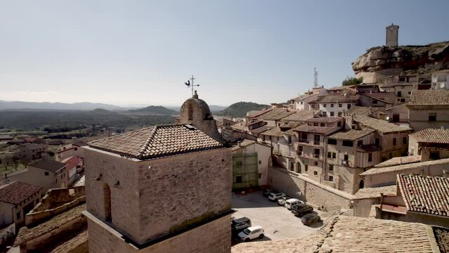 4K drone fly by over an old rural church tiled rooftop in Monroyo Village, Spain