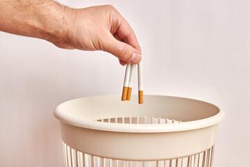 The cigarette is thrown into the trash. Disposal and recycling of plastic.