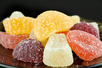 Multi-colored, marmalade candies, close-up, isolated on a black background.