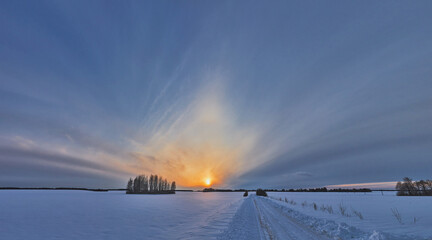 Sunset on a snowy road. Off-road on a snow-covered road.