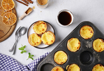 Pasteis de nata, typical Portuguese egg tart pastries from Lisbon on a set table. Top view